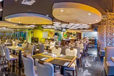 a dining room with tables and chairs in a restaurant at Infinity8 Bali in Jimbaran