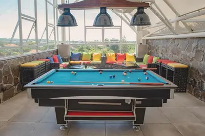a pool table in the middle of a room at Infinity8 Bali in Jimbaran