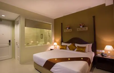 a bedroom with a large bed and a window at Amalfi Hotel Seminyak in Seminyak