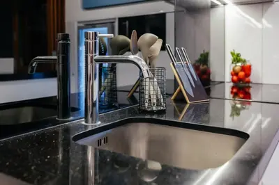 a kitchen counter with a sink in a kitchen at Kamil Villas in Seminyak