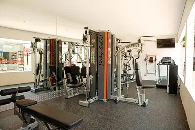 a gym with several tread machines in a room at Kamil Villas in Seminyak