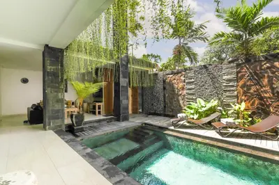 a swimming pool in the middle of a house at Puri Bagus Villa by Great Bali Villas in Legian