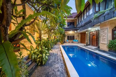 a swimming pool in a house with aiterraneaniterranean architecture at The Kutaya in Kuta