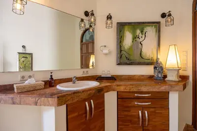 a bathroom with a sink and a mirror at Cove Urbanest Inn in Seminyak