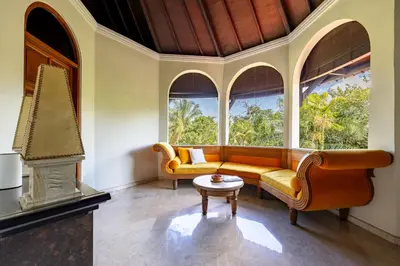 a living room with a couch and a table at Cove Urbanest Inn in Seminyak