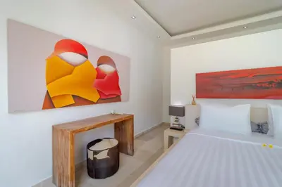 a bedroom with a bed and a painting on the wall at Gorgeous Tropical 3 Bed Pool Villa, 24hr Security in Seminyak