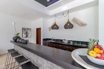 a kitchen with a counter with a bowl of fruit at Gorgeous Tropical 3 Bed Pool Villa, 24hr Security in Seminyak