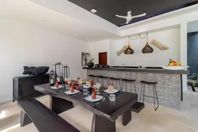 a dining room with a table and some chairs at Gorgeous Tropical 3 Bed Pool Villa, 24hr Security in Seminyak