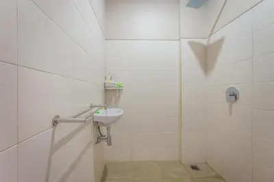 a bathroom with a sink and a shower at Room Valka Bali Seminyak in Seminyak
