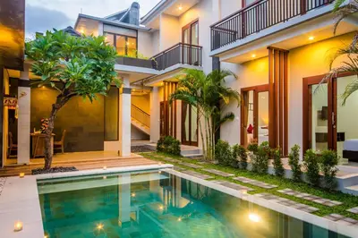a house with a swimming pool in front of it at Room Valka Bali Seminyak in Seminyak
