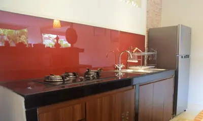 a kitchen with a sink and a refrigerator at Taman Amertha Villas by Maha Bali in Seminyak