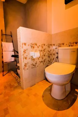 a bathroom with a white toilet in a room at Taman Amertha Villas by Maha Bali in Seminyak
