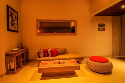 a living room with a couch and a table at Taman Amertha Villas by Maha Bali in Seminyak
