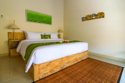 a bedroom with a large bed in a room at Taman Amertha Villas by Maha Bali in Seminyak