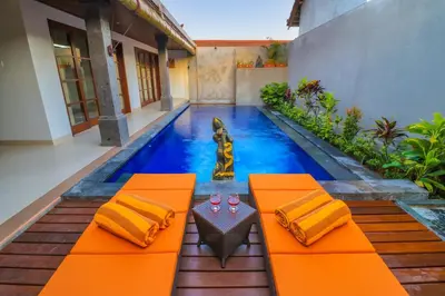 a swimming pool in the middle of a house at Taman Amertha Villas by Maha Bali in Seminyak