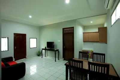 a living room with a couch and a table at Sari Indah Cottages in Kuta
