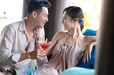 a man and a woman holding a drink at Holiday Inn Resort Bali Nusa Dua by IHG in Nusa Dua