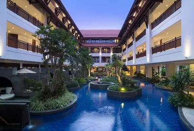 an indoor courtyard with a pool in a building at Holiday Inn Resort Bali Nusa Dua by IHG in Nusa Dua
