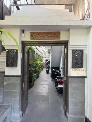 a doorway to a store with motorcycles parked outside at Paradise Inn in Legian