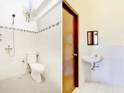 a bathroom with a toilet and a sink at Paradise Inn in Legian
