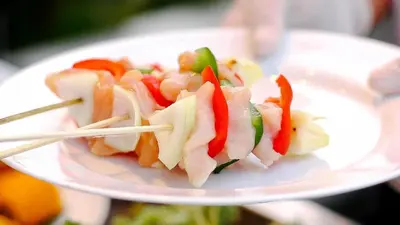 a plate of food on a plate with chopsticks at Aston Kuta Hotel and Residence in Kuta