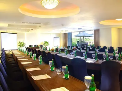 a conference room with long tables and chairs at Aston Kuta Hotel and Residence in Kuta