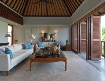 a living room with a white couch and a coffee table at The Legian Seminyak, Bali in Seminyak