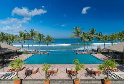 an image of a resort pool and the ocean at The Legian Seminyak, Bali in Seminyak