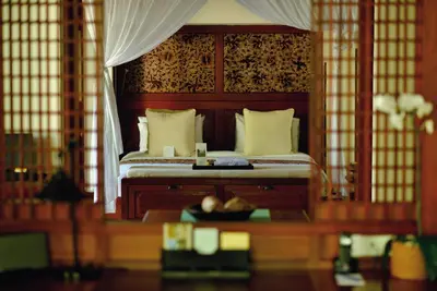 a bedroom with a canopy bed with a bowl of fruit at Jimbaran Puri, A Belmond Hotel, Bali in Jimbaran