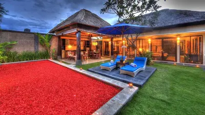 a house with a red carpet in the yard at Bali Rich Villas in Seminyak