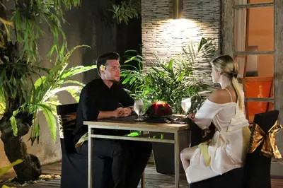 a man and a woman sitting at a table at The Wolas Villas in Seminyak