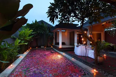 a backyard with a garden with red rocks and lights at Aria Exclusive Villas & SPA in Seminyak