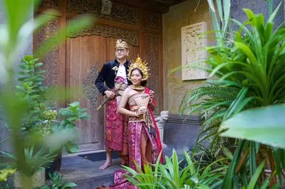 a man and a woman standing in front of a door at Risata Bali Resort & Spa in Kuta