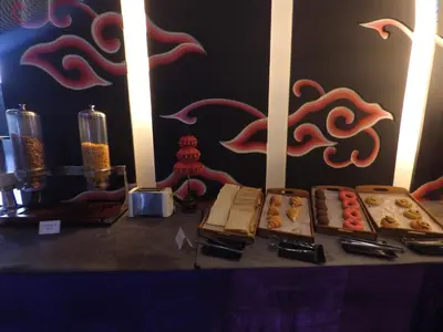 a table with a bunch of pastries on it at The Radiant Hotel in Kuta