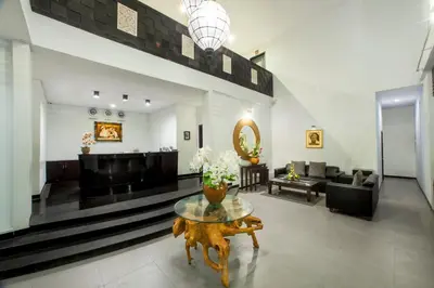 a lobby with a table with flowers on it at The Radiant Hotel in Kuta