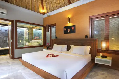 a bedroom with a large white bed in a room at Abi Bali Resort and Villa in Jimbaran