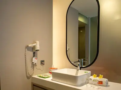 a bathroom with a sink and a mirror at HARRIS Hotel & Residences Riverview Kuta, Bali in Kuta
