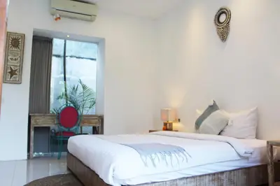 a bedroom with a large bed and a window at Villa Kim Seminyak in Seminyak