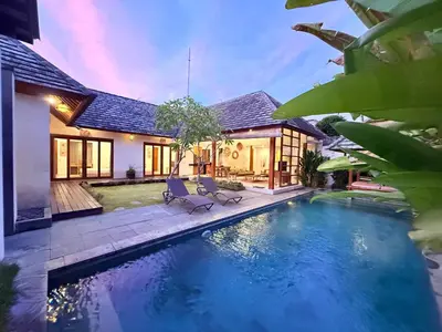 a house with a swimming pool in front of a house at Villa Kim Seminyak in Seminyak