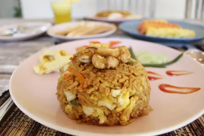 a plate of food with rice and shrimp on it at Villa Kim Seminyak in Seminyak