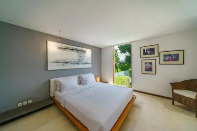 a bedroom with a large white bed and a window at Villa Rio - Contemporary 2BR Villa in Downtown Seminyak in Seminyak