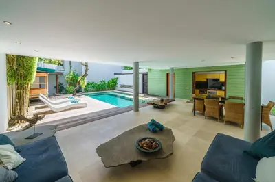 a living room with a pool and a house at Villa Rio - Contemporary 2BR Villa in Downtown Seminyak in Seminyak