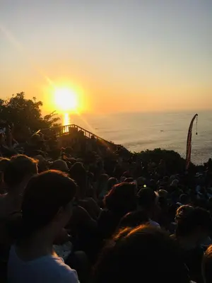 a large crowd of people watching the sunset at Nadialit in Seminyak