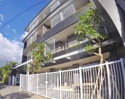 a building with a white fence in front of it at Pondok Nyaman 15 in Denpasar