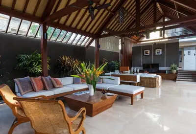 a living room with couches and a table and chairs at Villa Meliya in Canggu