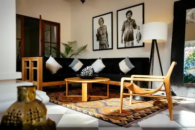 a living room with a black couch and a table at Villa Soleh in Seminyak