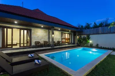 a swimming pool in the backyard of a house at Paisa Villa Seminyak in Seminyak
