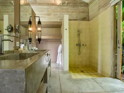 a bathroom with a shower and a sink at Villa Mannao by Villa Finder in Kerobokan