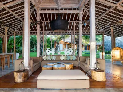 a living room with a couch in a pavilion at Villa Mannao by Villa Finder in Kerobokan