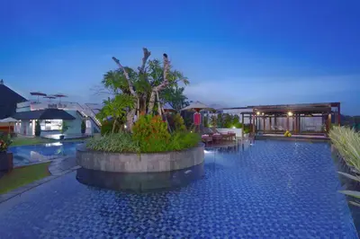a swimming pool in the middle of a villa at favehotel Kuta Kartika Plaza in Kuta